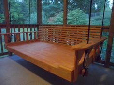 a wooden bench sitting on top of a porch