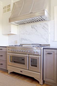 a stove top oven sitting inside of a kitchen