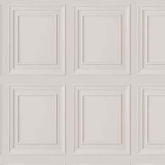 a white wall with many square panels on it