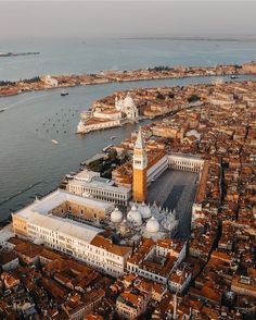 an aerial view of venice, italy with the grand canal in the foreground and other buildings