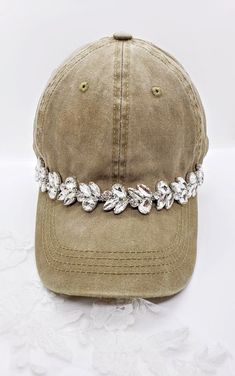 This is a new product from Handmade MKE! This is a distressed camel colored one size fits all baseball cap with a hole for your ponytail in the back, it is also adjustable. On the front of the hat is band of large diamante rhinestones that really sparkle! This is very comfortable, and great to throw on with a plain white T-shirt! Like our Facebook Page and get 10% off when you message me before checkout! Everything made by handmade MKE is one of a kind and unique, however, if you would like a di Baseball Cap Design Ideas, Unique Fashion Pieces, Bling Hat, Bone Bordado, Casual Hats, High Pony, Plain White T Shirt, Cute Caps, Hat Accessories