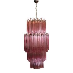 a pink chandelier hanging from a ceiling