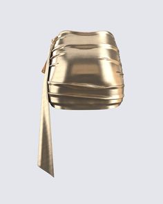 This golden drape skirt is your key to instant glam ✨ Made from lame jersey fabric, and complete with an asymmetrical hem, sash detail, ruching detail, and an elastic waistband - this skirt has a luminous allure perfect for stealing the spotlight anywhere you go 😌 Chic Gold Skirt, Chic Ruched Party Skirt, Chic Draped Wrap Skirt For Party, Chic Skirt With Ruched Sides For Night Out, Chic Ruched Skirt For Party, Glamorous Gold Skirt For Evening, Glamorous Gold Evening Skirt, Asymmetrical Ruched Draped Skirt For Party, Party Draped Skirt With Ruched Detail