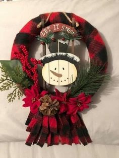 a christmas wreath with a snowman on it