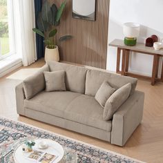 a living room scene with focus on the couch and coffee table in the foreground