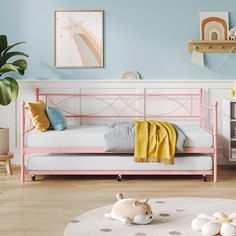 a pink daybed in a child's bedroom with blue walls