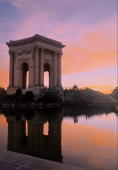 the water is reflecting the building and sky