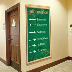 the information sign is on the wall by the door to the room where it is located