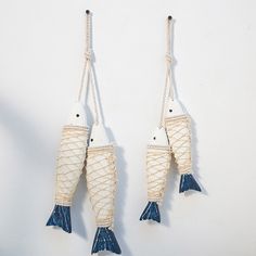 two white and blue fish hanging from ropes