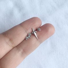 Real 925 Sterling Silver Mismatched Punk Goth Stud EarringsThese lovely earrings can be used in Earlobe, Second Earlobe hole, Cartilage, Helix and Tragus PiercingsThis set of earrings include 1 Bat, 1 Dagger and 1 SpiderMeasurement:• Bat- 9x5mm• Dagger - 5.75x14mm• Spider- 6.5x5mmComes with pushback backingsJewelry will come in a gift box* Please read shop policy before placing an order * Goth Helix Piercing, Silver Cartilage Earrings, Bat Earring, Second Hole Piercing, Pjo Dr, Random Clothes, Jewelry Piercing, Boho Hoop Earrings, Bat Earrings