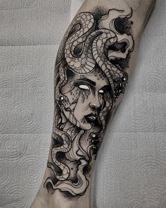 a woman's face with a snake on her leg