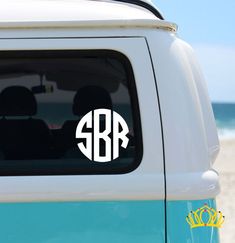 the monogrammed sticker on the back of a van is shown in white