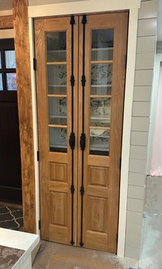 two wooden doors with glass inserts on them