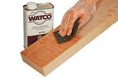 a person using a sponge to apply danish oil on a piece of wood with the words how to apply danish oil