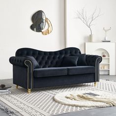 a black couch sitting on top of a white rug