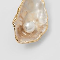 an oyster shell with a pearl in it