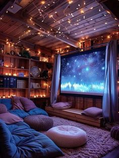 a living room filled with lots of furniture and lights hanging from the ceiling above it