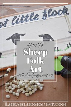 a sign that says how to sheep folk art with lots of little rocks in front of it