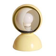 a white light bulb sitting on top of a yellow stand with an open hole in the middle