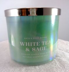 a white tea and sage candle on a towel