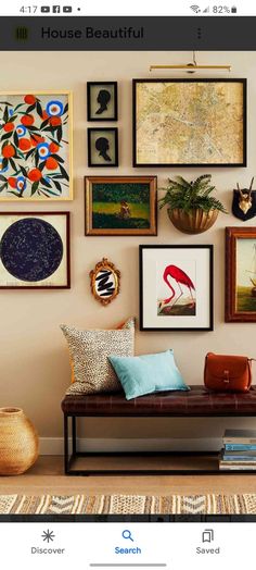 a living room filled with lots of pictures on the wall above a couch and coffee table