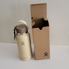 a bottle and box sitting next to each other on a white counter top with a wall in the background