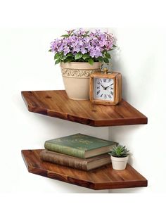 two wooden shelves with flowers and books on them, one shelf has an alarm clock