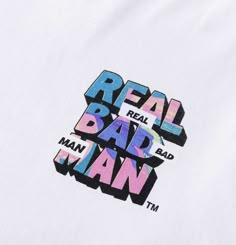 the real bad man t - shirt is white with multicolored letters on it