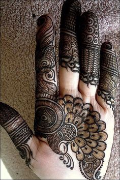 the hand is decorated with henna on it