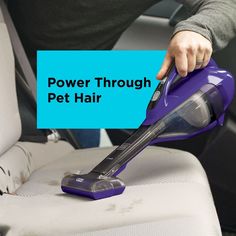 a person using a vacuum to clean a car seat with the words power through pet hair