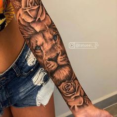 a woman's arm with a lion and roses tattoo on the left side of her body