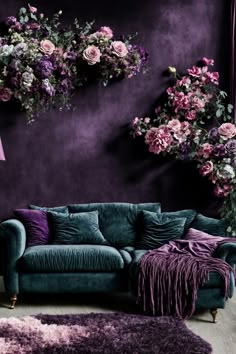 Immerse yourself in this lavish living room that's like stepping into an enchanted garden. The captivating Ombre wall decor paints a background of deep purple, perfectly blending with a lush hanging garden of roses and mixed blooms. A luxurious teal velvet sofa adorned with plush violet pillows calls for relaxed conversations and dreamy afternoons. Paired with a soft, sumptuous throw and complemented by a rich, shaggy rug, the space is a texture lover’s paradise. Ombre Wall Art, Purple Living Room, Moody Decor, Ombre Wall, Purple Rooms, Set Sofa, Dark Home Decor, Purple Walls, Ideas Living Room