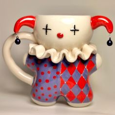 a ceramic figurine with a red nose and white face