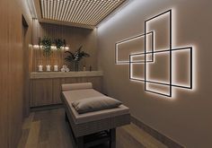 a dimly lit spa room with white lights on the walls and wood flooring, along with a bench