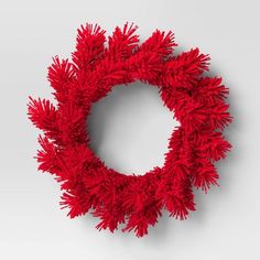 a red wreath is hanging on the wall