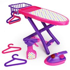 a toy ironing board and accessories on a white background