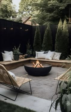 an outdoor fire pit surrounded by chairs and trees