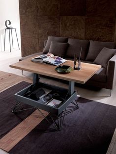 a coffee table with an open drawer underneath it