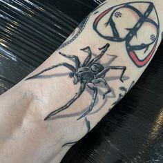 a spider tattoo on the arm and leg