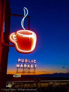 a neon sign that says public market with a cup of coffee on it