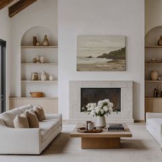 a living room filled with furniture and a fire place in front of a painting on the wall