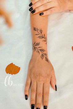 a woman's hand with leaves on it