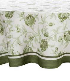 a table cloth with pomegranates and green leaves on it, in front of a white background