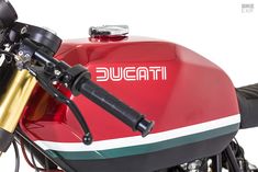 a red and white motorcycle with the word ducati on it's front end