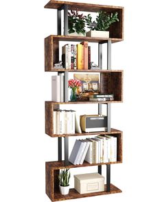 a bookshelf filled with lots of books next to a plant and other items