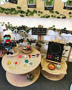 two children's tables with signs and toys on them