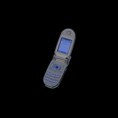 an old cell phone is shown in the dark