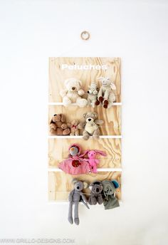 several stuffed animals are hanging on a wall