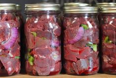 jars filled with pickled vegetables and meat