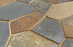 a close up of a stone floor with different colors and shapes on it's surface